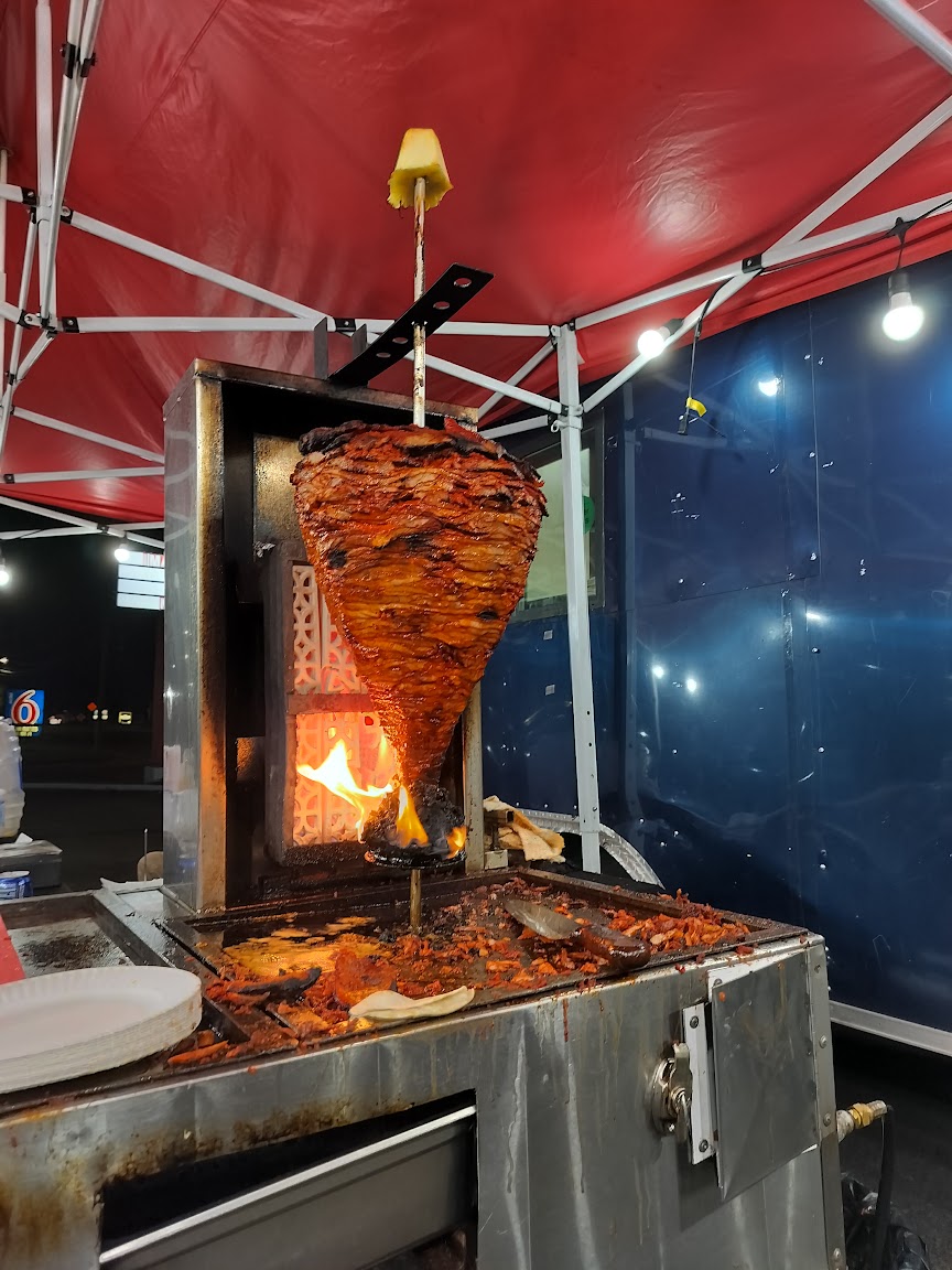 Trompo al pastor cooking over open flame